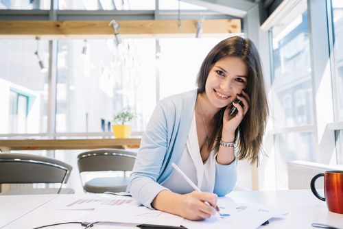 businesswoman with a pen and a phone