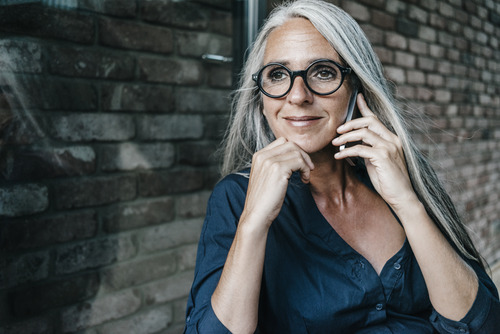 A senior businesswoman holding a phone