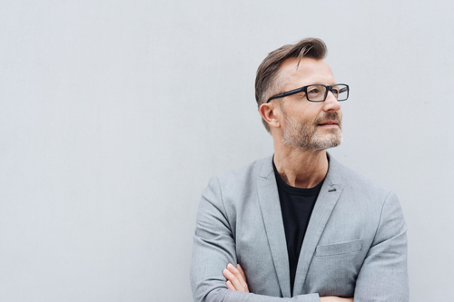 A senior businessman with arms crossed