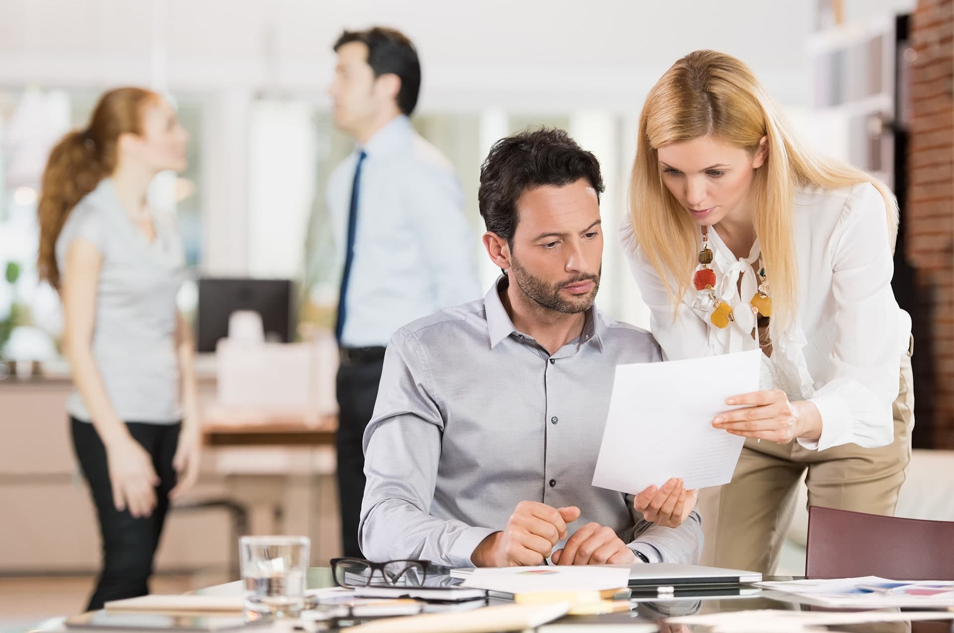 man-and-woman-discussing-document-in-office-lhh