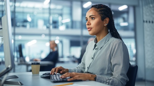 businesswoman typing in front of a computer