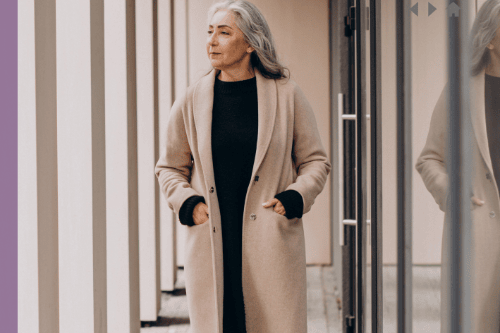 A senior businesswoman walking in an office hallway