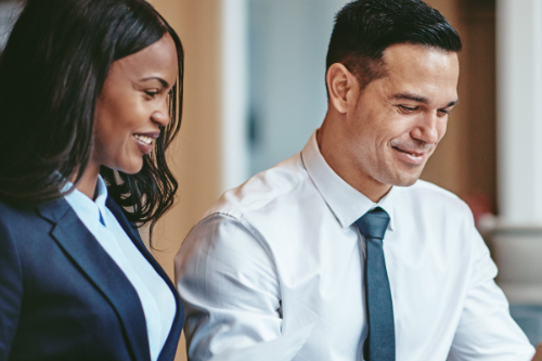 Two businesspeople smiling