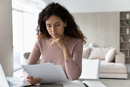 pensive-young-hispanic-woman-sit-desk