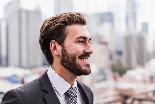 A businessman looking away and thinking about attracting and retaining top talent with competitive salaries and strategic benefits