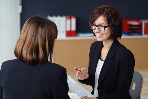 Two businesswomen taking about how to succeed in their new job