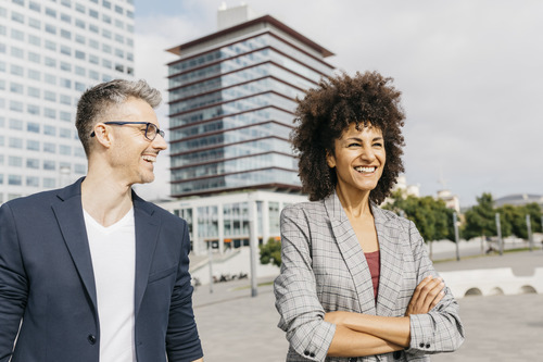 two businesspeople smiling