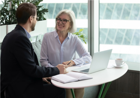 Senior executive mentoring colleague in office