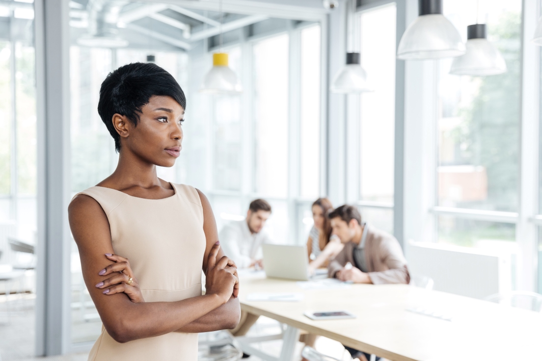 Woman leader with her team collaborating in the background