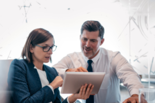 Two businesspeople looking at a report