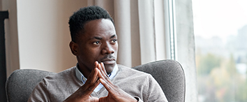 Picture of man sitting in chair and looking through the window