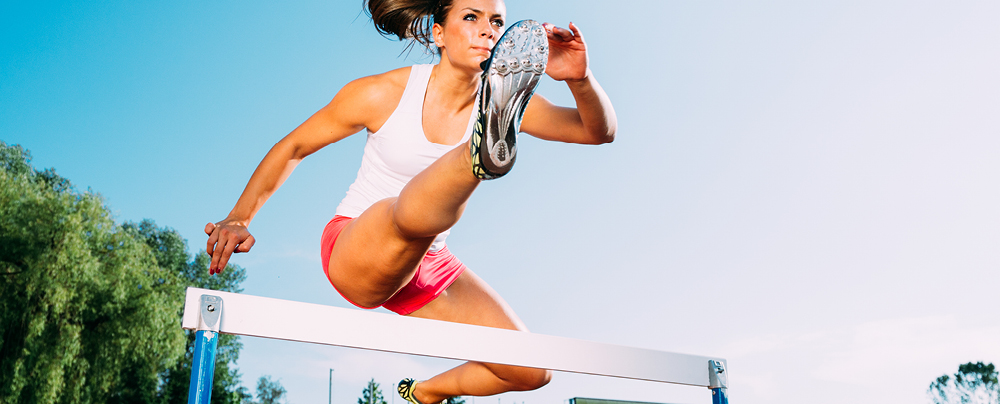 Picture of athlete woman jumping over the bariere