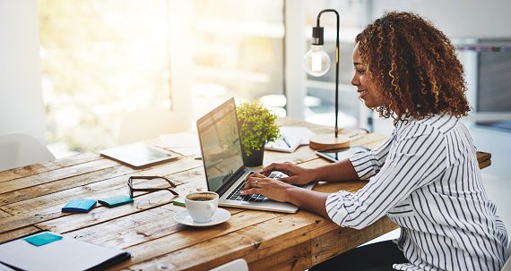 woman sitting in home office at computer