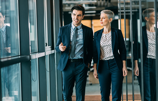 two executives walking through office hall