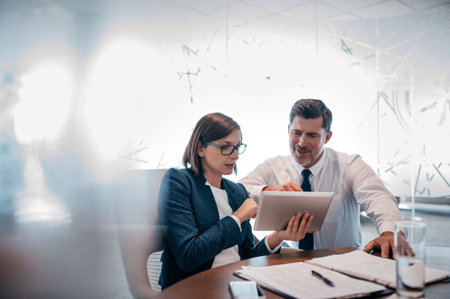 Two businesspeople looking at a report