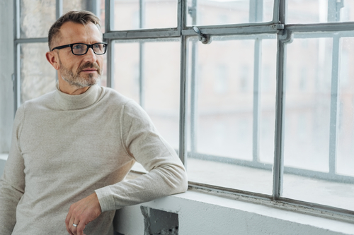 senior businessman sitting by a window