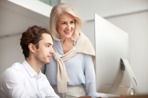 two businesspeople looking at a computer