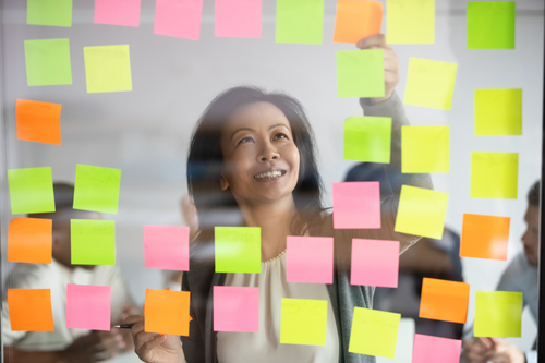 businesswoman facing a lot of post it cards