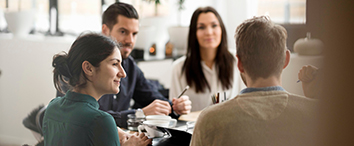 Picture of people sitting on office desk and talking