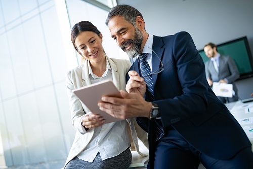 two businesspeople looking at a tablet