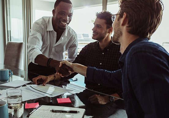 Three businessmen sealing a deal