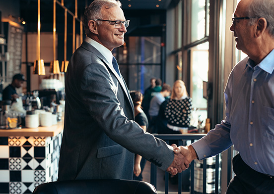 Two senior businessmen shaking hands