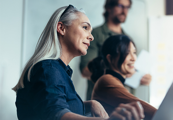 A senior businesswoman leading an office meeting